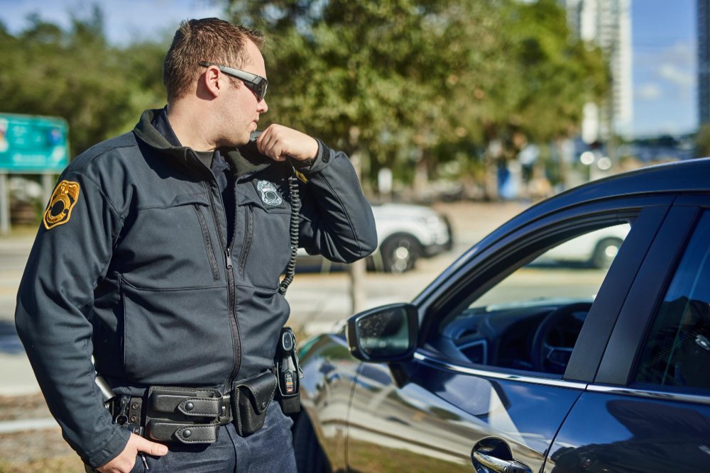 Security officer outdoor on patrol while talking to radio