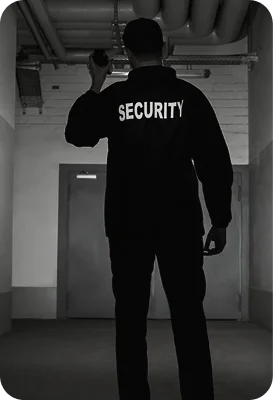 Back view of a security officer conducting a patrol while communicating.